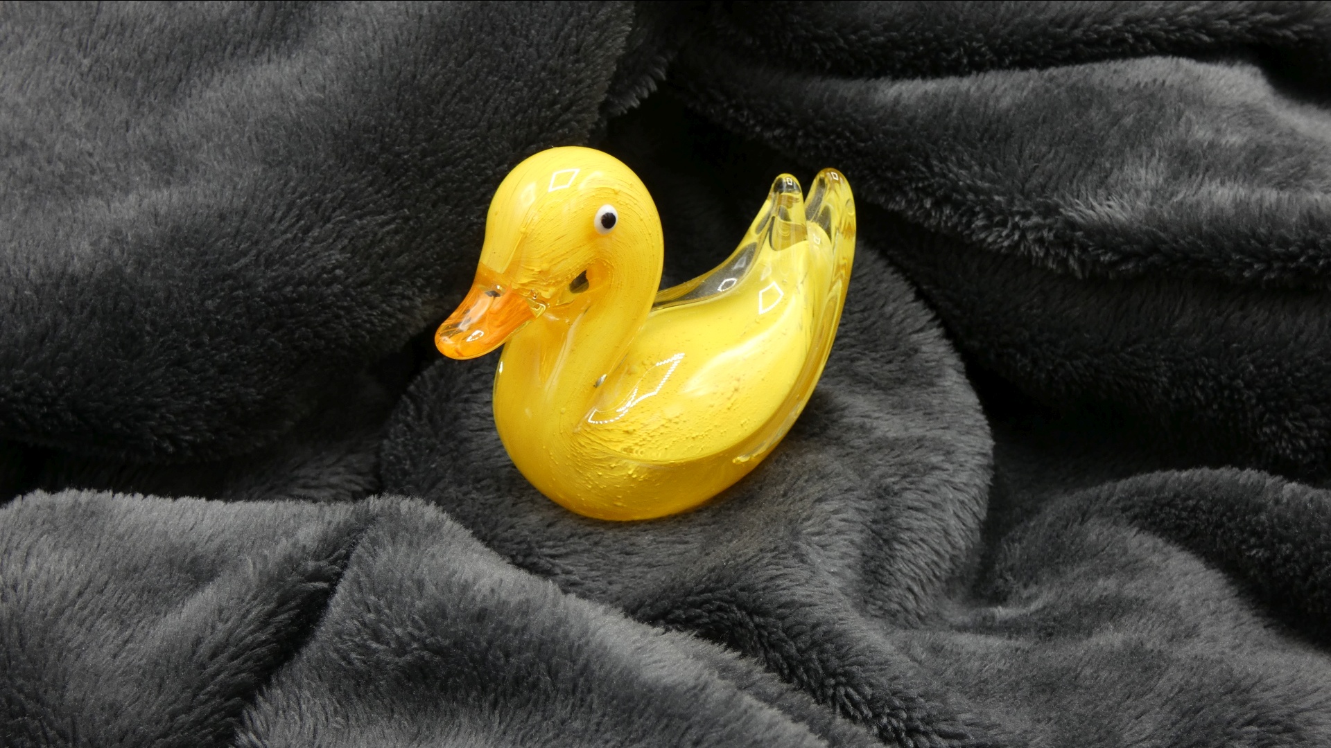 Glass Ducky on a Gray Blanket
