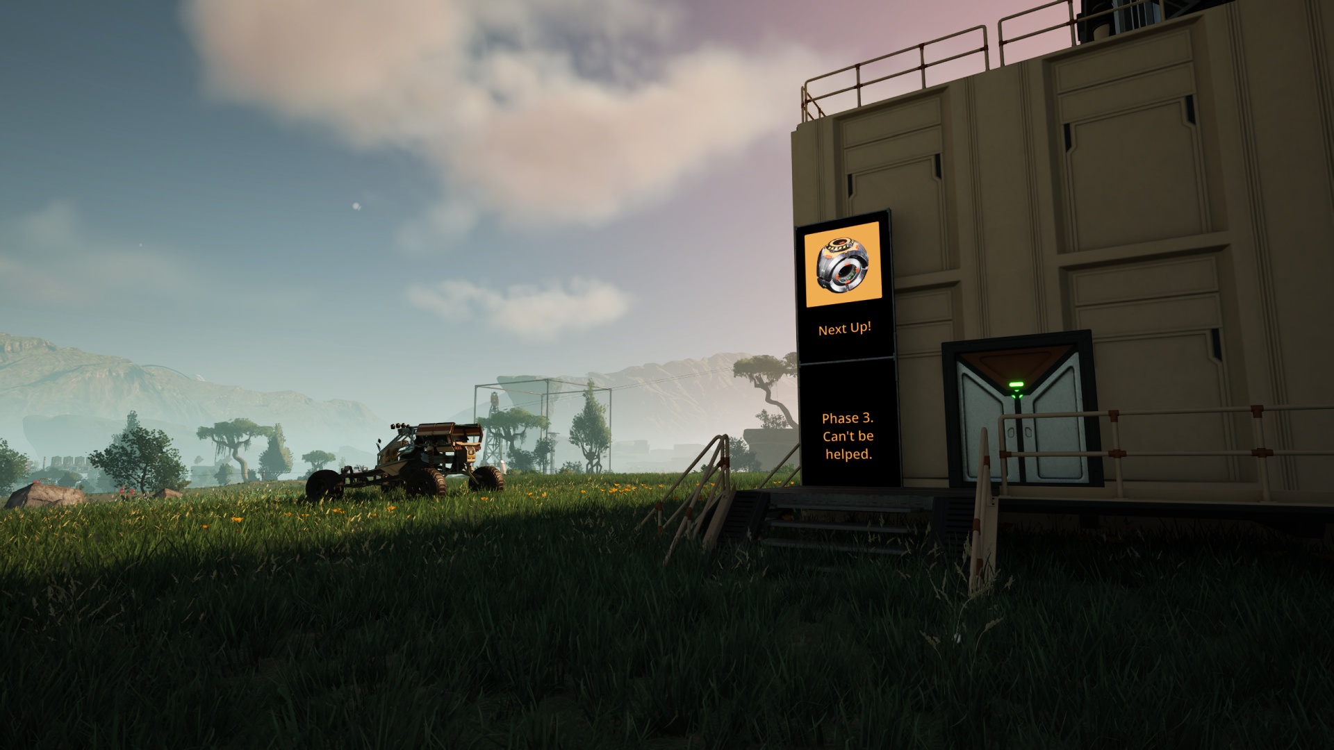 Satisfactory video game screenshot: Late-afternoon view showing puffy clouds in the sky above the Hub building, on which is a sign reading, "Phase 3. Can't be helped." The Explorer vehicle is next to the building, and in the distance one can see the Mk2 Blueprint Designer.