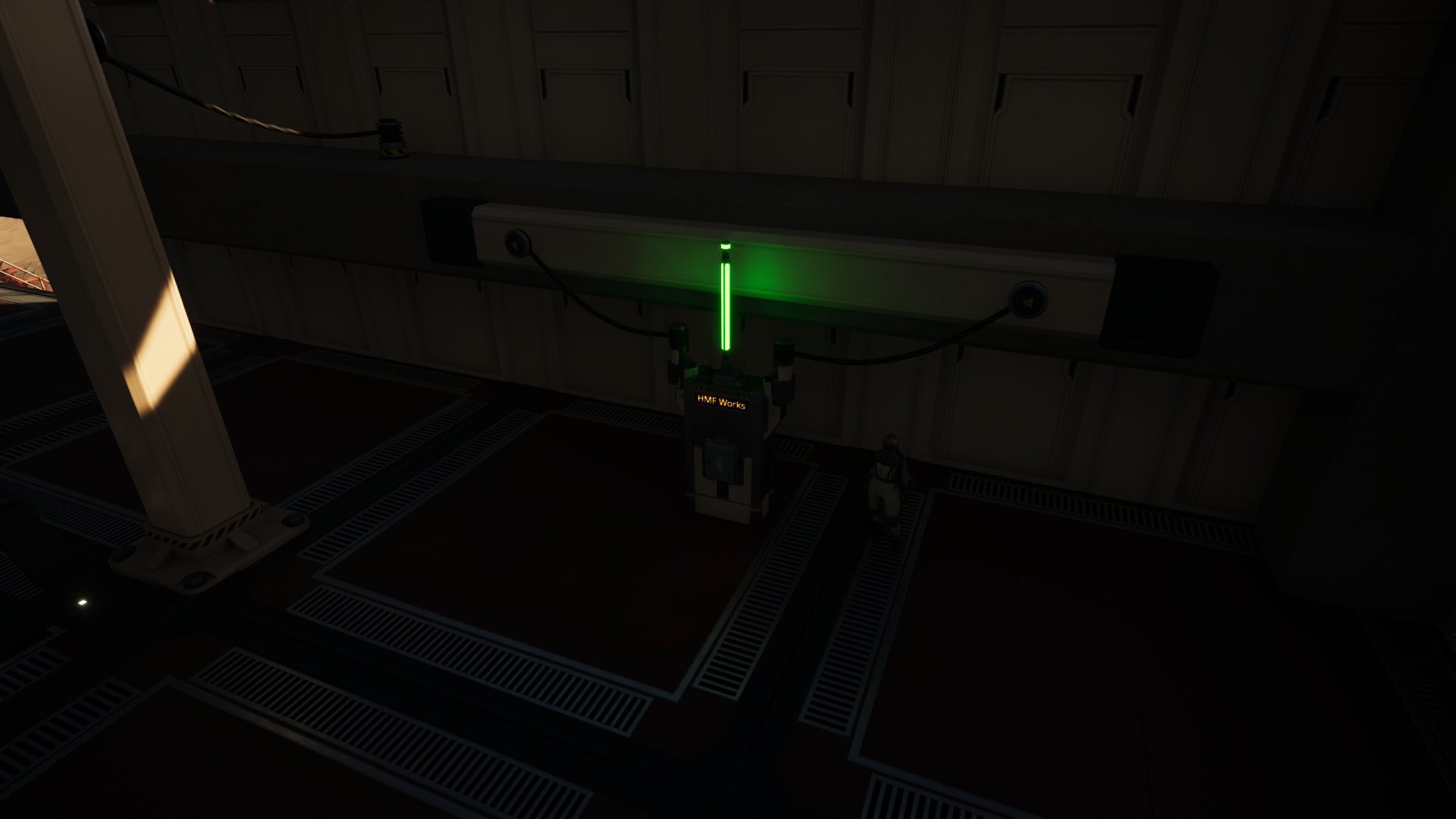 Satisfactory video game screenshot: Dimly lit interior view of a factory building. The Pioneer stands next to a power switch labeled "HMF Site".